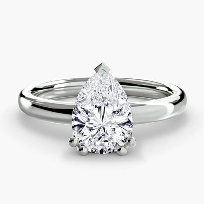 Diamond ring with pear-shaped gemstone on a white background