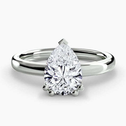 Diamond ring with pear-shaped gemstone on a white background