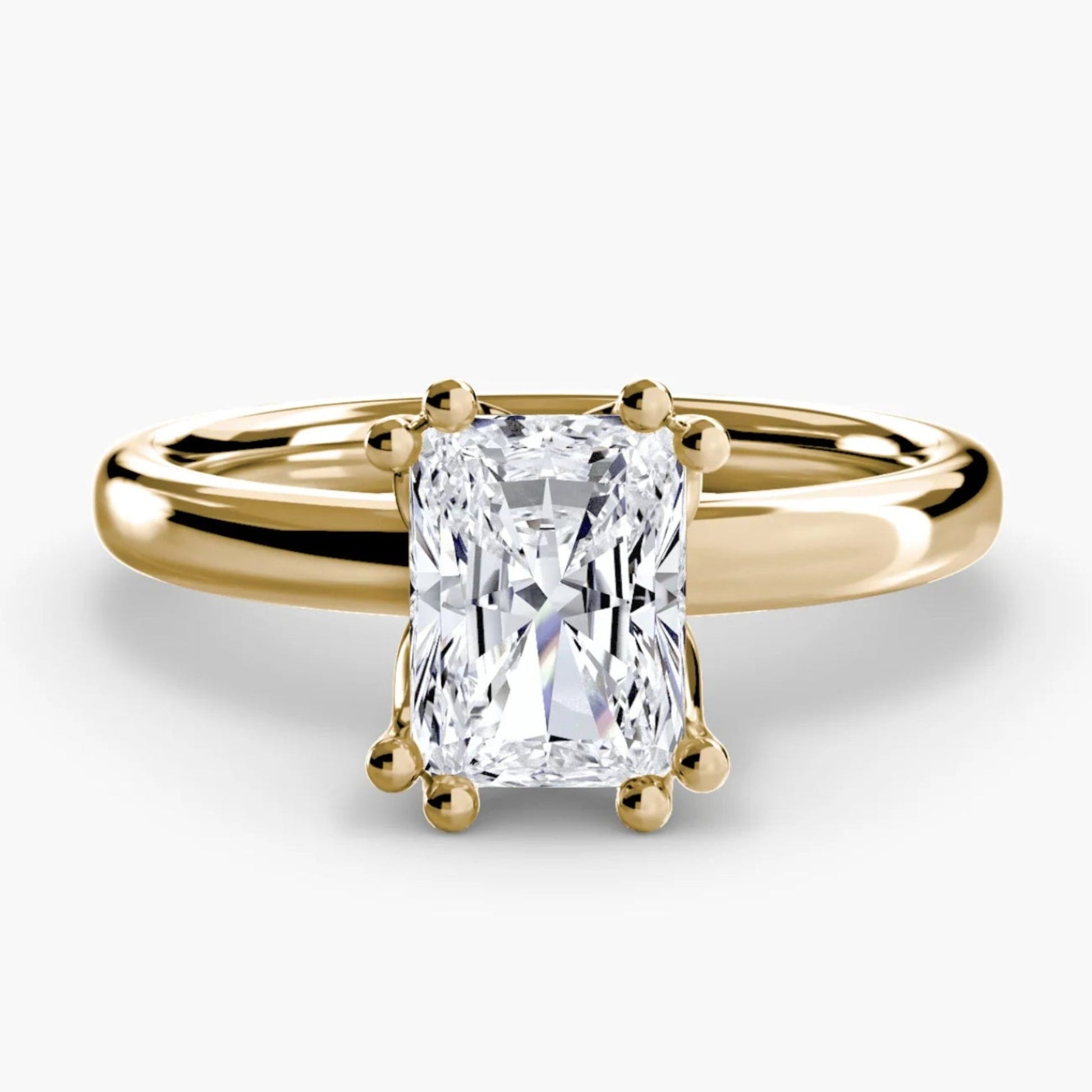 Gold ring with a diamond on a white background