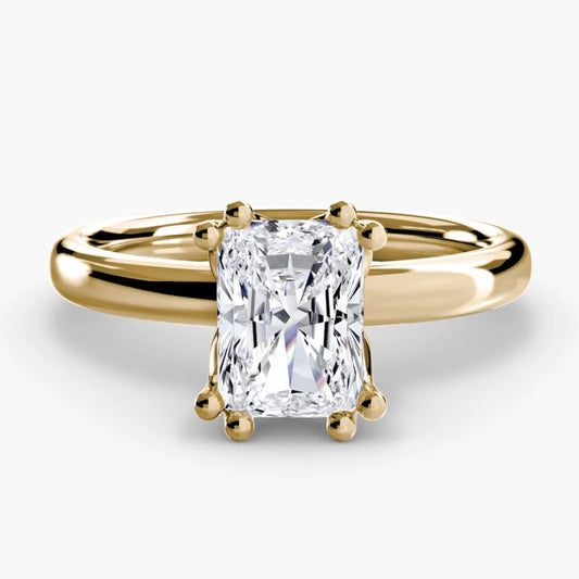 Gold ring with a diamond on a white background