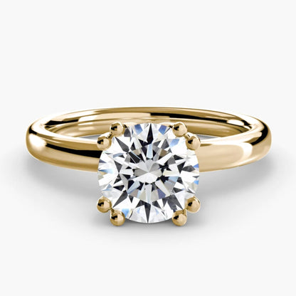 Gold ring with a diamond on a white background