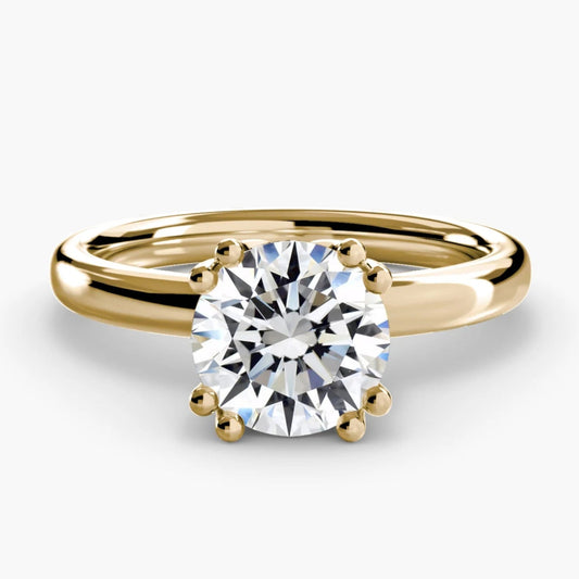 Gold ring with a diamond on a white background